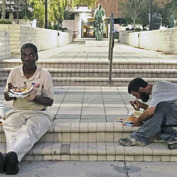 two homeless men sitting on sarasota court steps