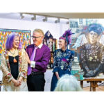 Artist Vicki Chelf, gallery owner Paul Sykes and Second Heart Homes founder Megan Howell stand next to “Second Heart Angel,” the Chelf painting honoring Howell